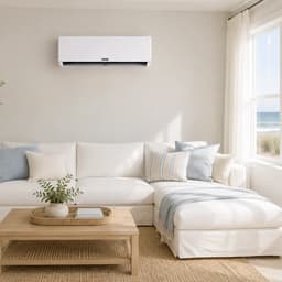 Zone Air wall mount mini split above a white sectional in a living room with an ocean view