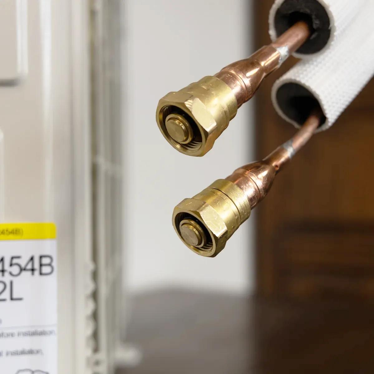 Mini split pre-charged line-set — brass quick-connect couplings on a Zone Air pre-charged line set that hand-thread onto the unit service ports