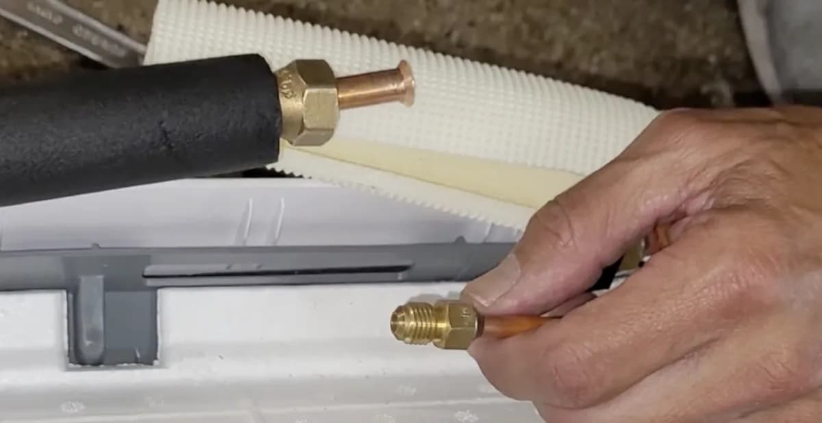 Traditional mini split flare connection: a flare nut and female flare on the line set next to the male flare fitting it screws onto